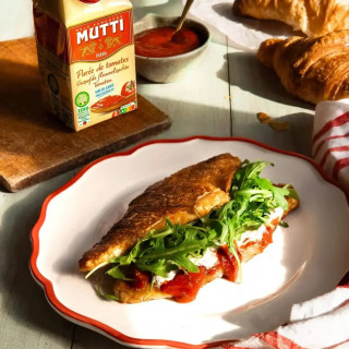un croissant croustillant à la Purée de tomates Mutti Zéro Résidu de Pesticide, de la burrata crémeuse et de la roquette fraîche